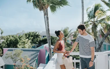 couple talking by palm trees