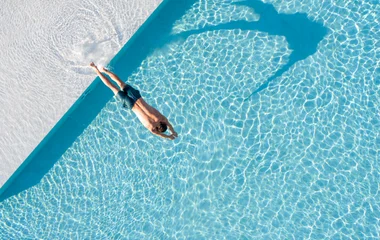 person diving into pool