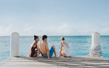 friends on a dock by the beach