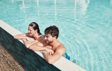 Pareja de hombre y mujer en la piscina.