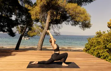 Mulher praticando yoga ao ar livre.