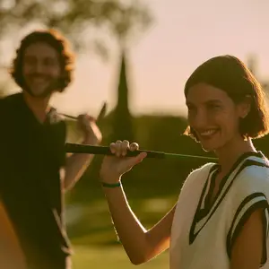 Two people playing golf