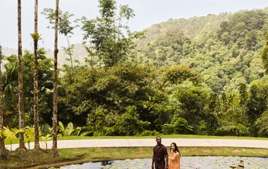 Pareja caminando por un pasaje sobre un río.