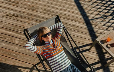 mujer en reposera al sol