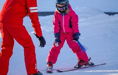 Criança aprendendo a esquiar.