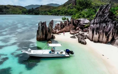 Exploring the beautiful Seychelles beaches with a boat