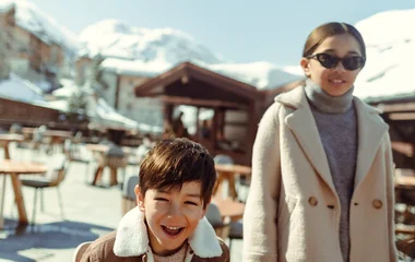 Family eating sandwich at the out door main bar at ski resort