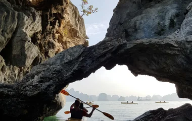people kayaking in a cave