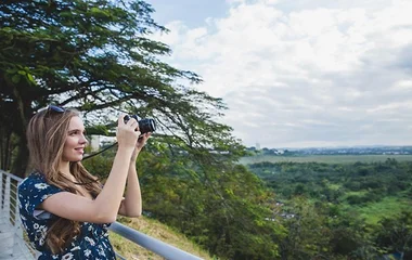 A girl captures photos of birds soaring in the sky