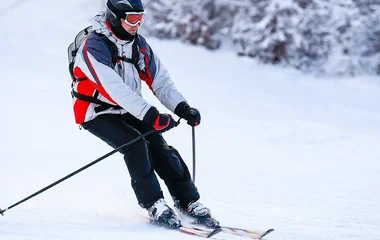A man and a woman walking on a beach with palm trees