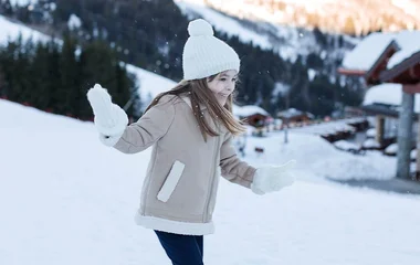 Little girl playing in the snow