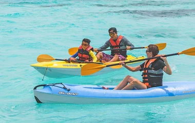 Family kayaking in turquoise waters