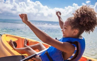 Child kayaking in Cancun Mexico