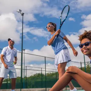 Family playing tennis on holiday
