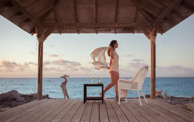 lady having a drink on the deck in the bahamas