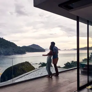 Couple overlooking the beach in a resort in Rio