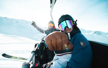 skiers on the ski lift chair