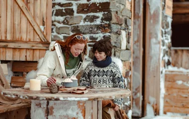 woman and child on a snowy terasse