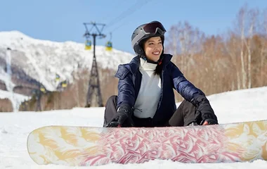 girl on a snowboard in club med winter resort