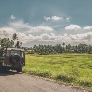 a car stopped in front of the rice fields in Bali