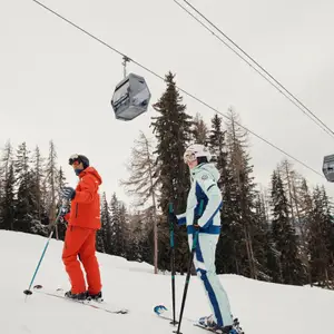 ski instructor and person learning in the slopes