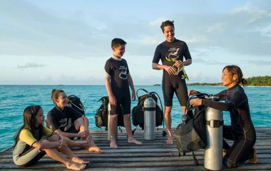 a family prepares to go diving at a resort