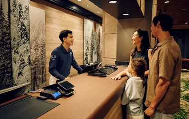 Picture of a family in front of the reception in Kiroro Grand