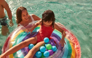 A young girl with her family in the pool