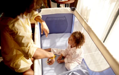 Bebê no berço e sua mãe no quarto do Club Med