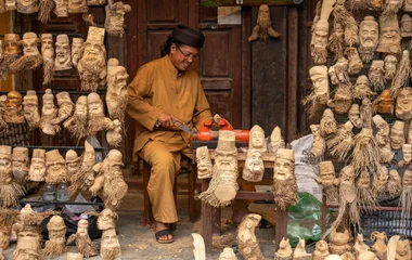 A man sculpting wooden figures in Malaysia