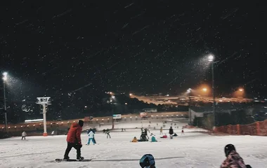 People skiing at night