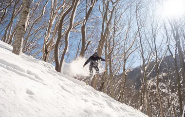 Men mid-air snowboarding.