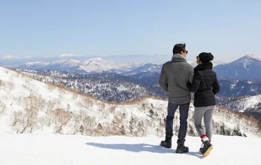 Couple looking at the snowy landscape.