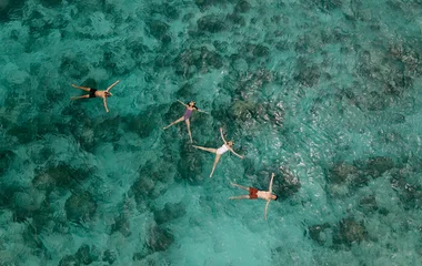 People floating on the ocean.