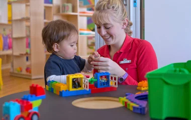 Woman playing with toddler.