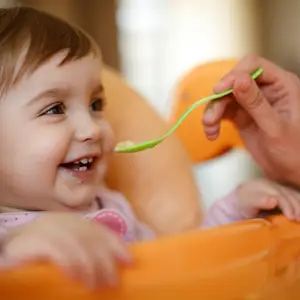 Baby eating baby food.