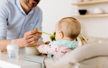 Baby getting fed baby food.