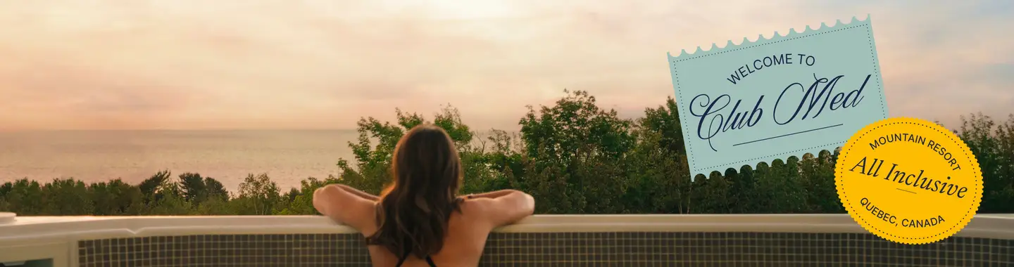 A woman seen from behind in a jacuzzi in front of the sunset