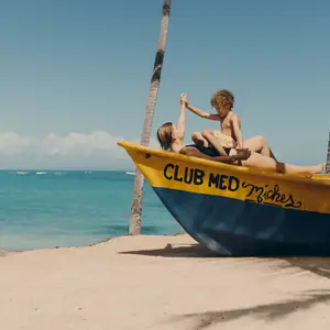 Mom and kid on the boat at the beach.